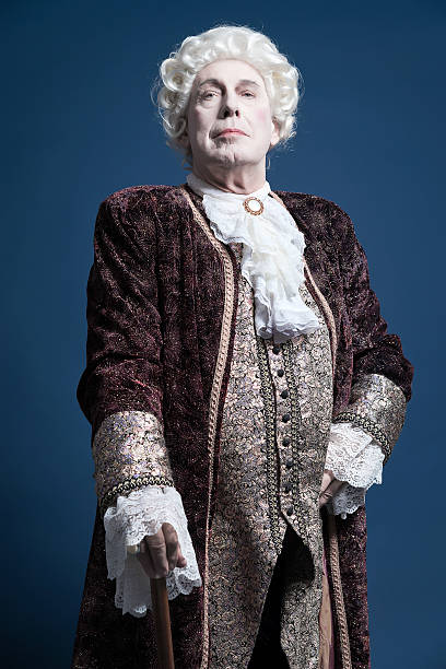 istock Retro baroque man with white wig standing with walking stick. 498785557