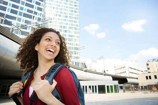 istock Woman smiling with backpack in the city 498786861