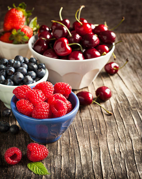 istock Fresh berries in bowls on wooden background. 498790905
