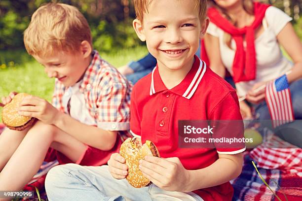 Eating Hamburger Stock Photo - Download Image Now - 30-39 Years, 6-7 Years, Adult