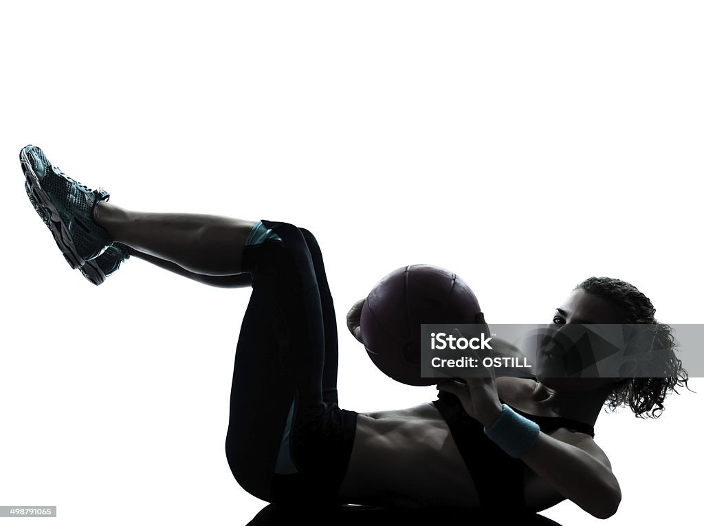 woman exercising fitness ball workout silhouette one woman exercising fitness ball workout crunches in silhouette studio isolated on white background In Silhouette Stock Photo