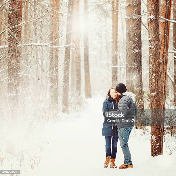 Young Couple Embracing In Winter Forest Stock Photo - Download Image Now - 20-29 Years, 25-29 Years, Adult