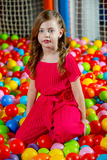 istock Little girl having fun while playing in the ball pool. 498796934