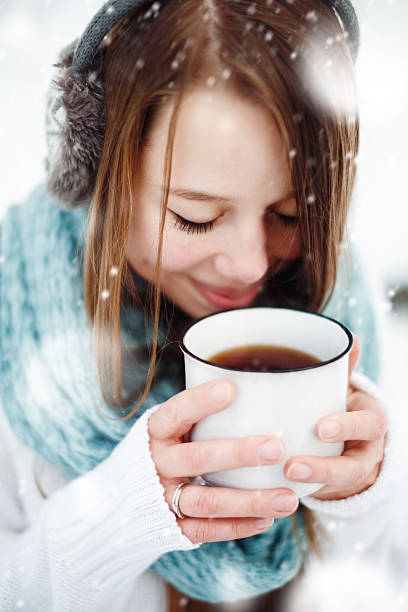istock Female Drinking Hot Drink Outdoors in Winter 498797408