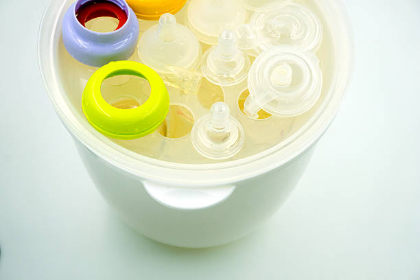 istock Steaming and sterilizing milk bottles for baby 498797440