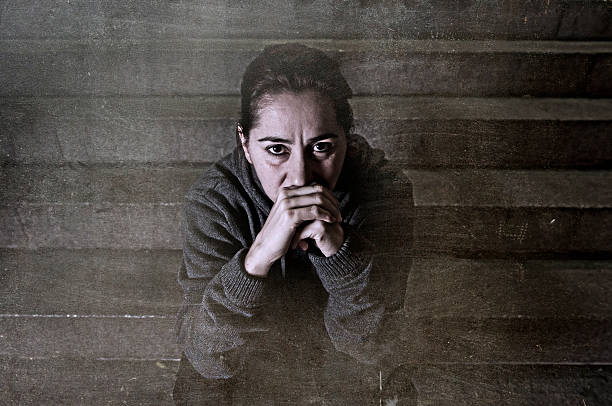 istock sad sick woman alone on street subway staircase suffering depression 498797678
