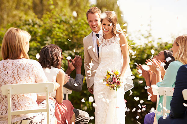 istock Guests Throwing Confetti Over Bride And Groom At Wedding 498799152