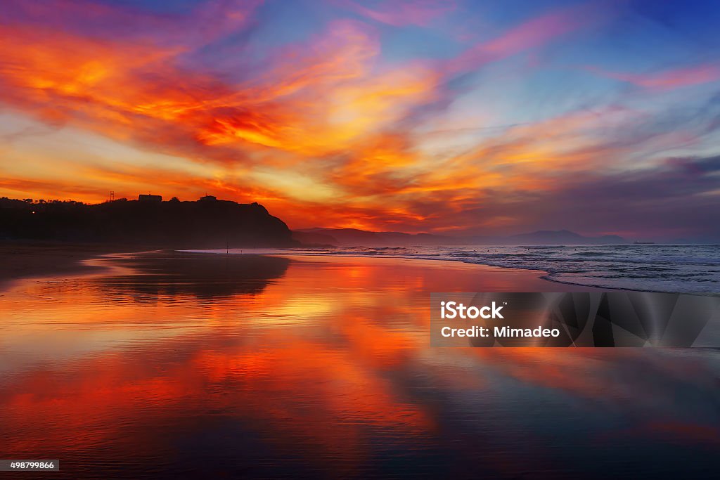 red sunset in Sopelana beach red sunset in Sopelana beach with reflections; 2015 Stock Photo