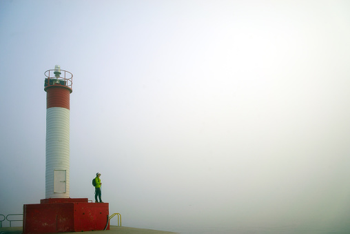 woman hiker enjoy the view at  peak near lighthouse