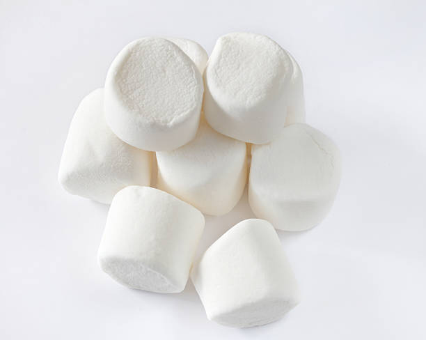 Heap of large marshmallows.  Isolated on white.  Close-up. stock photo