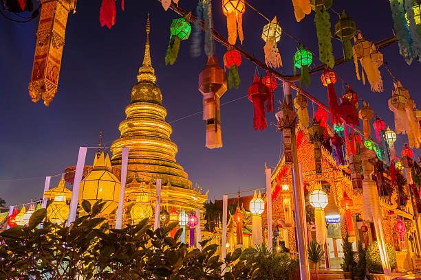 Gold pagoda and lantern hung up on the rail Gold pagoda and lantern hung up on the rail to the prosperity in loy kratong festival at wat phra that haripunchai lamphun Thailand at night time ayuthaya photos stock pictures, royalty-free photos & images