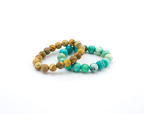 isolated turquoise and brown bracelet stone on white background
