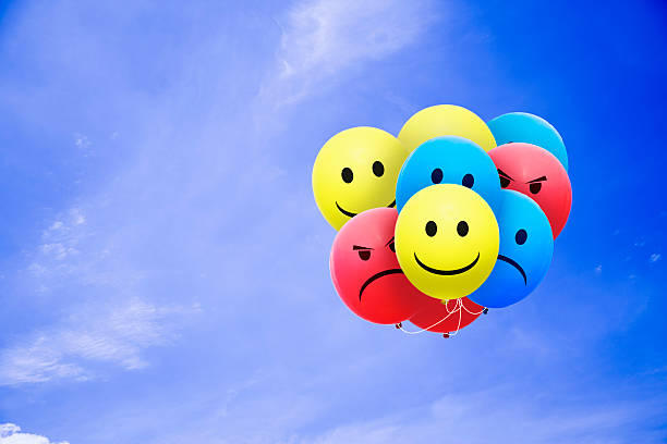 istock Bright balloons flying in the blue sky with a smiley 498807794