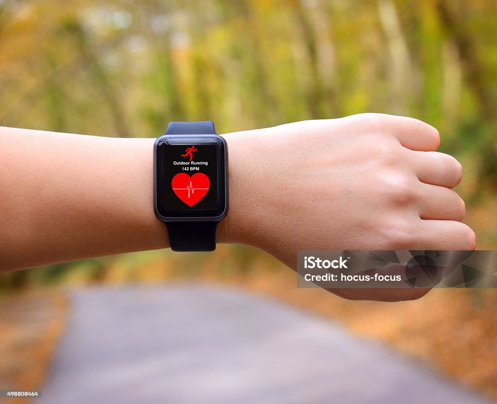 Wearable technology smart watch Runner using smart watch with heart rate application on a running track. Watch - Timepiece Stock Photo