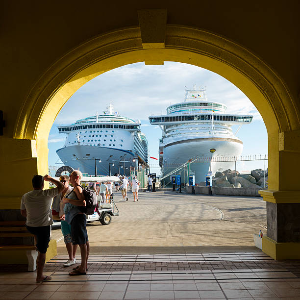 Basseterre, Saint Kitts and Nevis - November 14, 2013: Cruise passengers enjoy final moments in the port of Basseterre before reboarding their vessels, Royal Caribbean International's Adventure of the Seas (left) and the P&O Ventura (right).