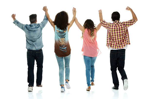 istock Rear view of four people cheering 498810919