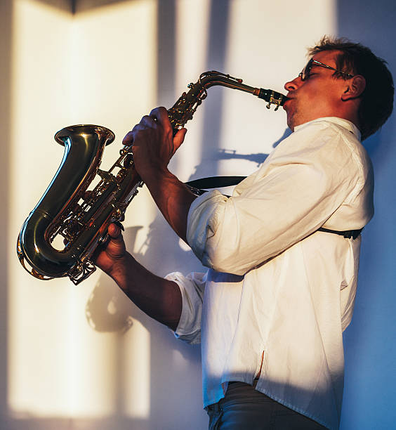 istock one young man playing his saxophone in the sunlight 498810975
