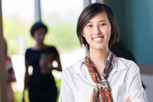 Pretty young Asian woman stading in modern building lobby