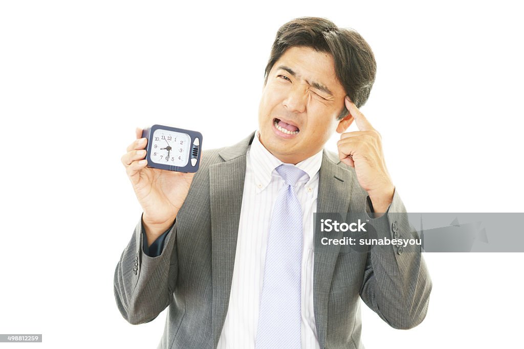 Stressed Asian businessman Portrait of Asian businessman who has no time Adult Stock Photo