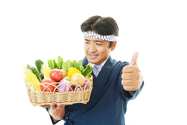 istock Smiling Japanese chef with vegetables 498826373