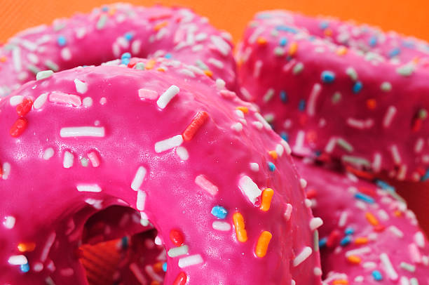 istock donuts coated with a pink frosting 498826949