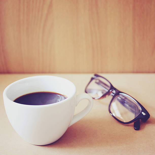 istock Hot coffee and eyeglasses with retro filter effect 498827169
