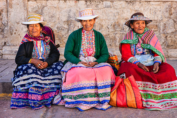 Peruvian women in national clothing, Chivay, Peru Chivay is a town in the Colca valley, capital of the Caylloma province in the Arequipa region, Peru. Located at about 12,000 ft above sea level, it lies upstream of the renowned Colca Canyon. It has a central town square and an active market. Ten kilometers to the east, and 1,500 meters above the town of Chivay lies the Chivay obsidian source. Thermal springs are located 3 km from town, a number of heated pools have been constructed. A stone "Inca" bridge crosses the Colca River ravine, just to the north of the town. The town is a popular staging point for tourists visiting Condor Cross or Cruz Del Condor, where condors can be seen catching thermal uplifts a few kilometers downstream.http://bem.2be.pl/IS/peru_380.jpg peruvian culture stock pictures, royalty-free photos & images