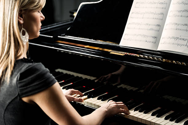 istock Woman playing piano. 498828043