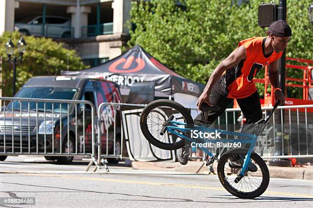 Man Practices Flatland Bmx Tricks Before Competition Stock Photo - Download Image Now