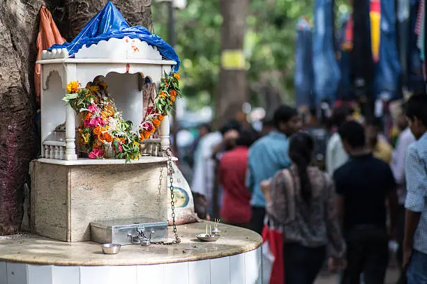 A small hindu shrine in the afternoon next to the market on Fashion Street in Mumbai, India
