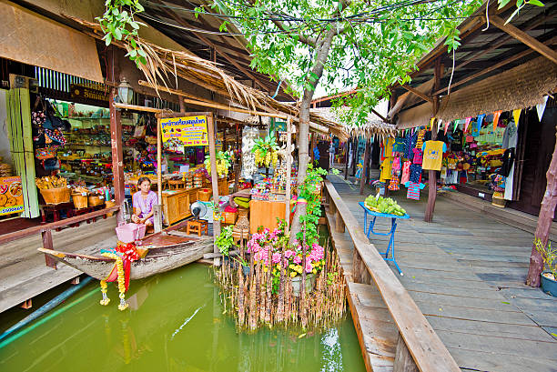 Pattaya, Thailand - December 29, 2023: Floating open air market with small houses - shops on the pond in Pattaya, Thailand. High quality photo
