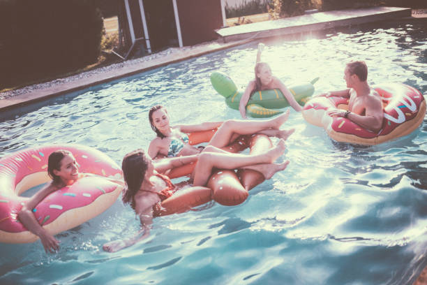istock Five friends floating in a pool together with inflatables 498830834