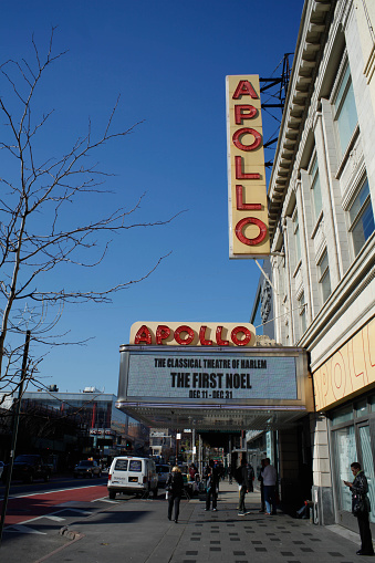 New York City, NY, USA - November 25, 2015: View of Apollo Theater on 125th street. People on street. 