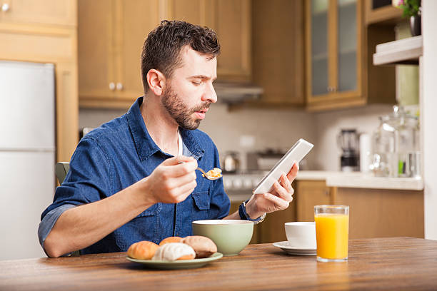 istock Man reading news over breakfast 498832288