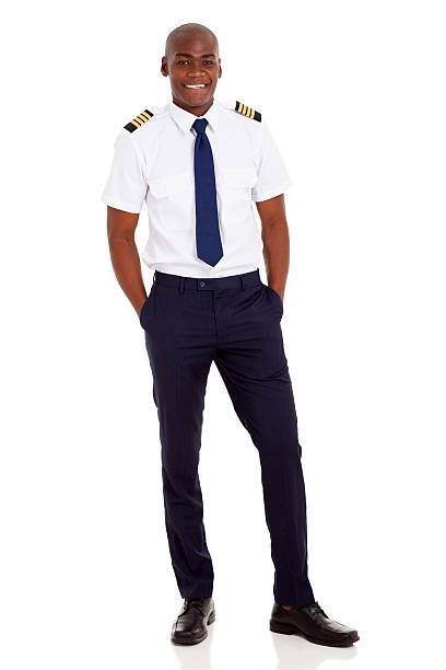 istock african airline pilot standing over white background 498832577
