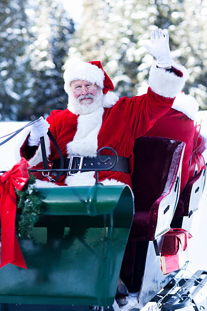 istock Santa Claus Waving in His Sleigh 498832694