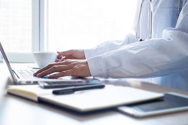 istock Doctor typing information on the computer in office 498833056