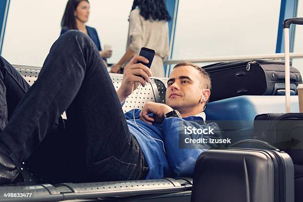 Waiting For The Flight Stock Photo - Download Image Now - Airport Departure Area, Lying Down, Men