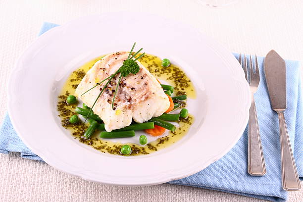 istock Cod fillet with green beans, peas, parsley, olive oil 498834029