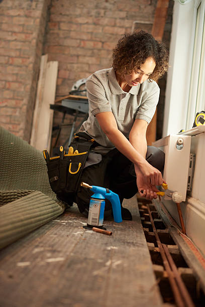 istock female plumber radiator installation 498840982