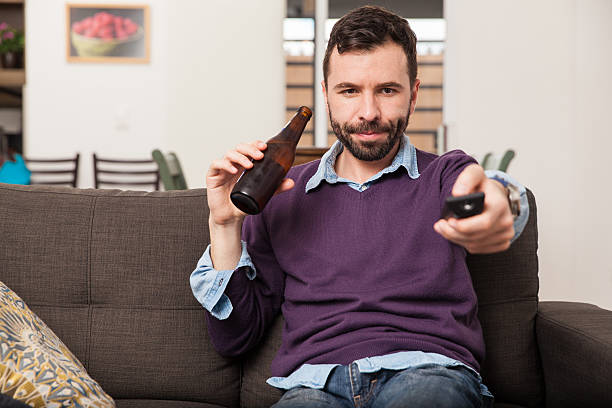 istock Man watching the game at home 498841680