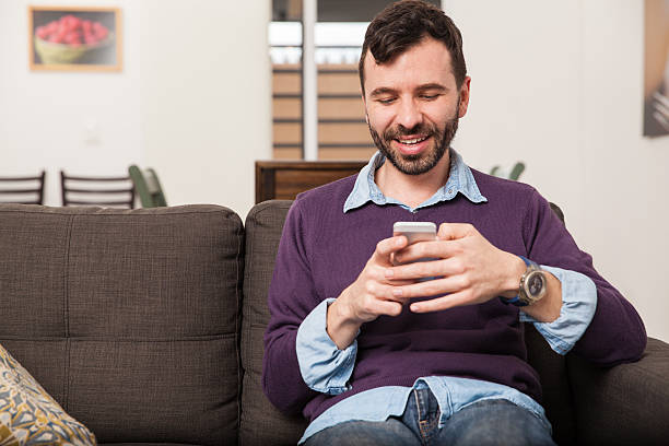 istock Man texting and relaxing at home 498842678