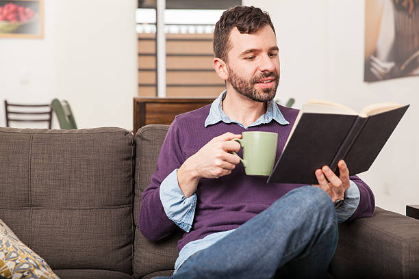 istock Man relaxing and reading at home 498843090
