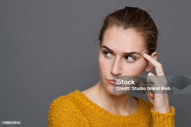 Unhappy Young Woman Looking Dubiousexpressing Confusion And Mistrust Stock Photo - Download Image Now