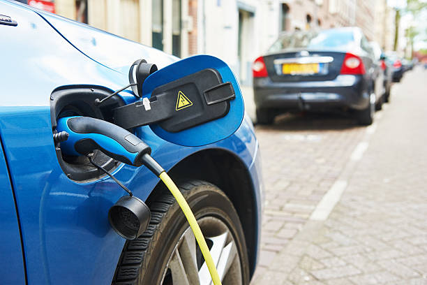 istock power supply plugged into an electric car during charging 498844180