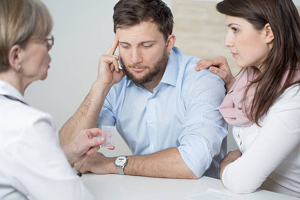 istock Ill man and assisting wife 498845238