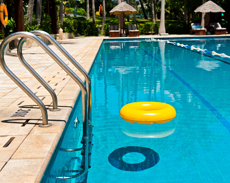 A yellow lifering on swimming pool.