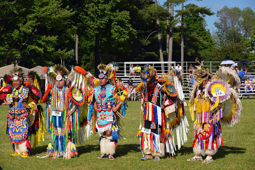 Ottawa, Canada - June 22, 2014: Native men stand before judges after performing traditional dance in Summer Solstice Aboriginal Arts Festival for Aboriginal Day in Massey Park in Ottawa, Canada