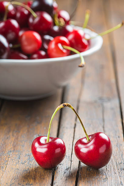 istock White bowl of cherries on the table 498850863