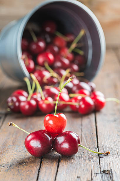 istock Little brass bucket of cherries on a table 498851543